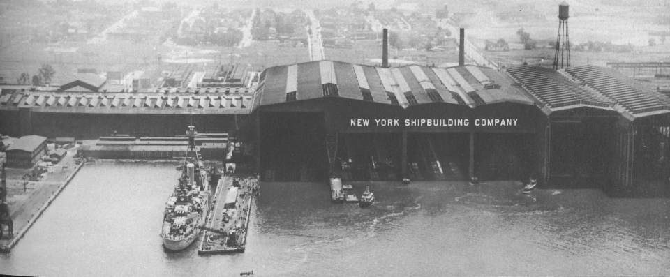 A waterfront view showing New York Ship’s distinctive covered ways under which work can be carried on relatively independent of the weather.
